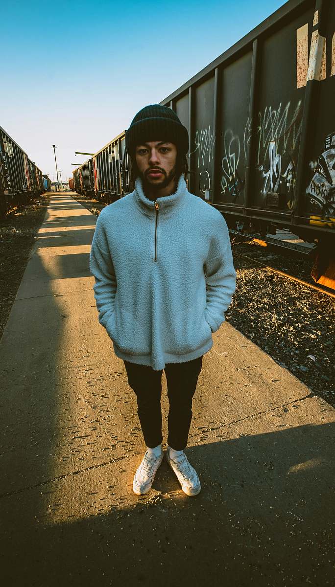 apparel man in gray jacket standing near trains clothing