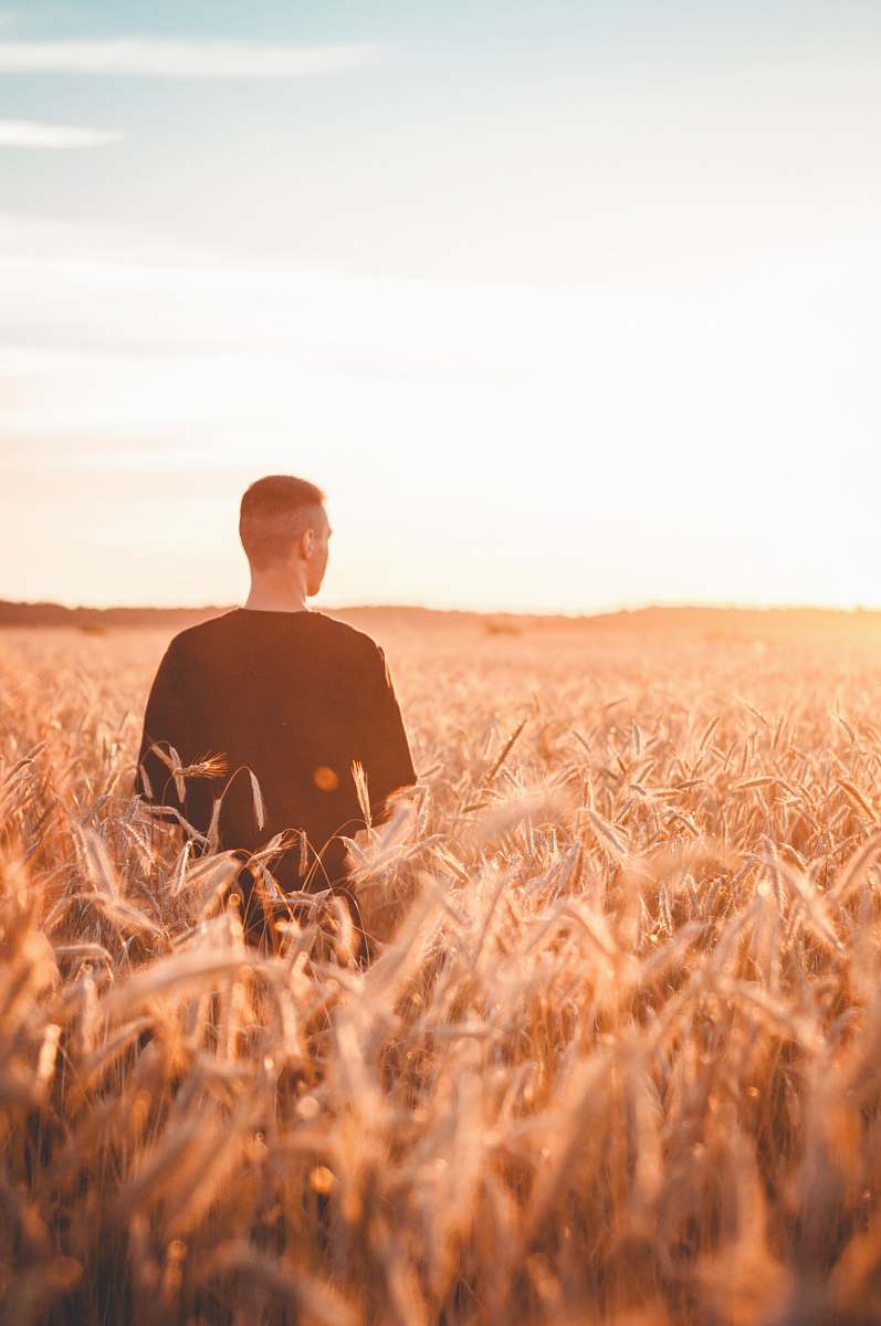 nature man wearing black shirt standing on grasses outdoors
