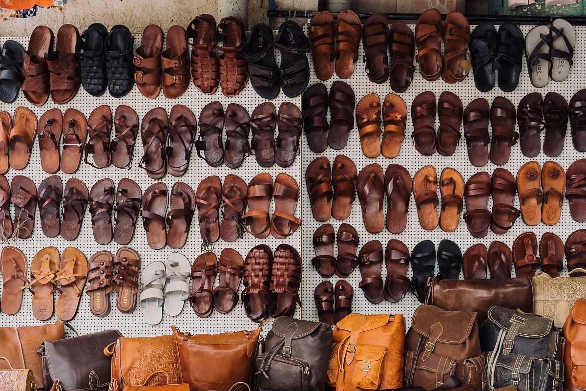 human pairs of assorted sandal lot on white textile people