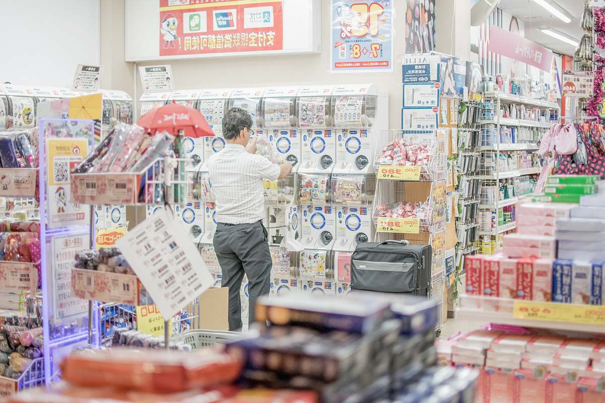 human person facing plastic packs inside store people