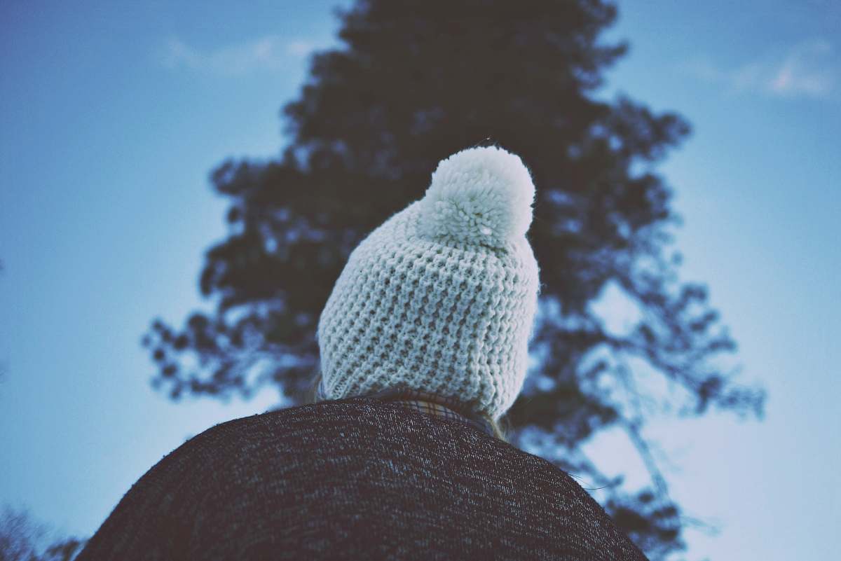 beanie person in front of tree during daytime hat