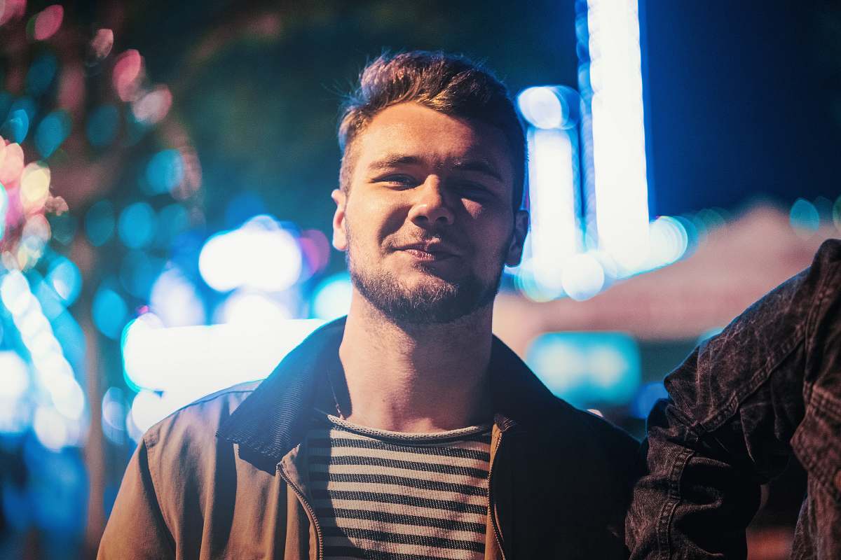 human selective focus photography of man wearing brown zip-up jacket people