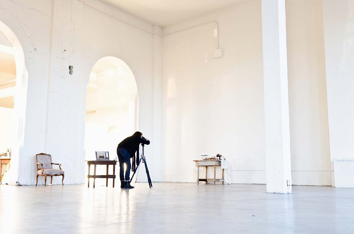 interior woman on gray and black tripod stand with telescope furniture