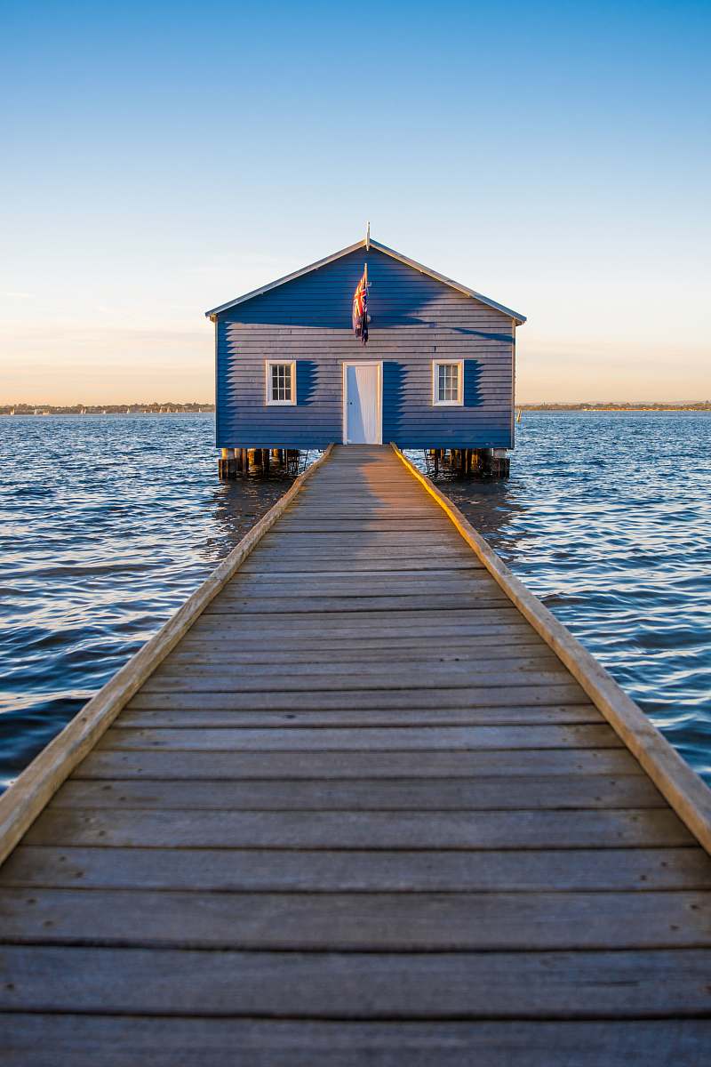 dock blue and white wooden house on sea under clear blue sky during daytime sea