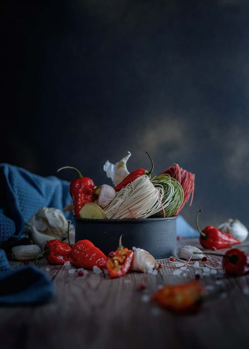 food black cup surrounded by chills garlic