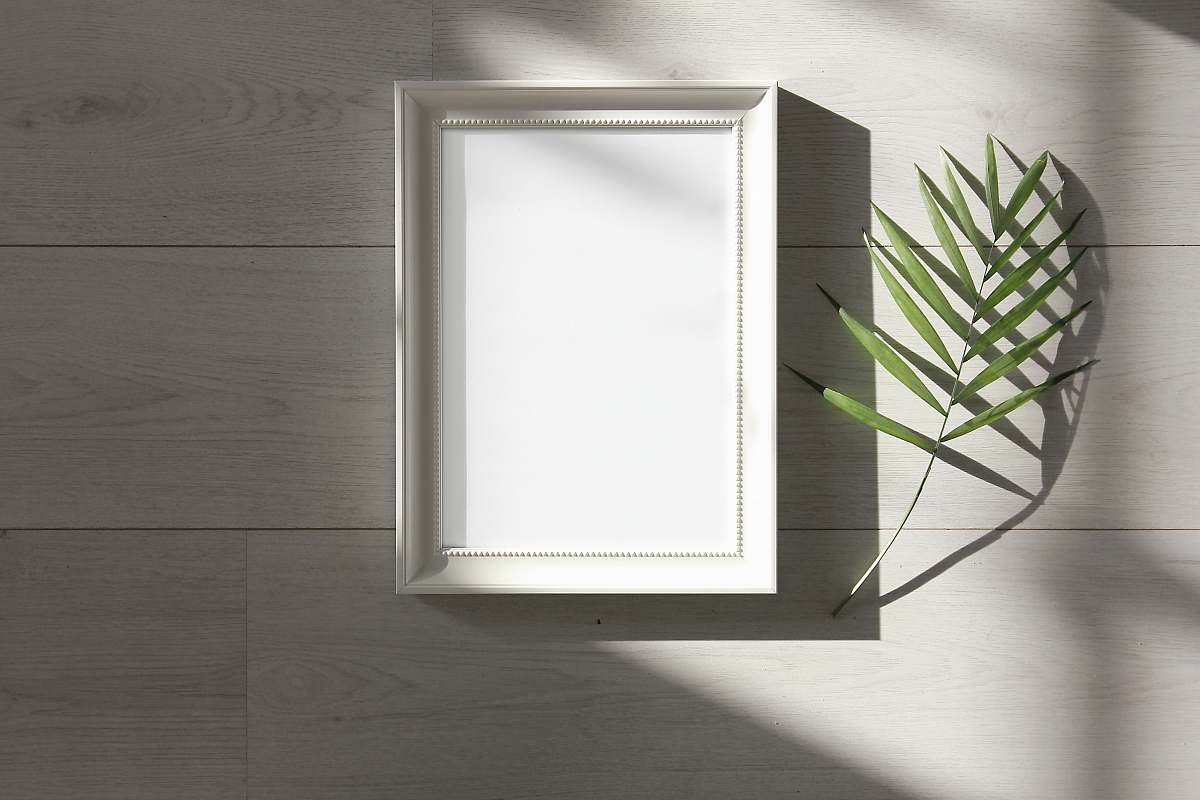 frame green-leafed beside white photo frame pineapple