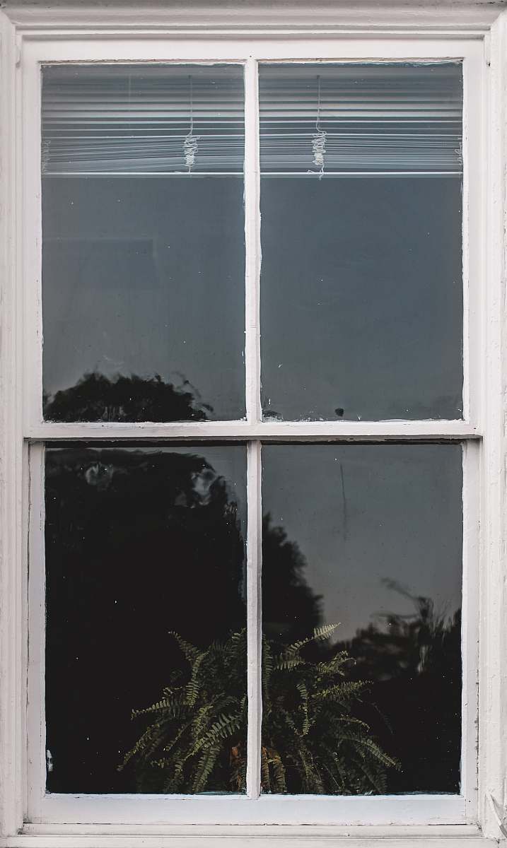 window white wooden frame glass panel window with white window blinds shadows