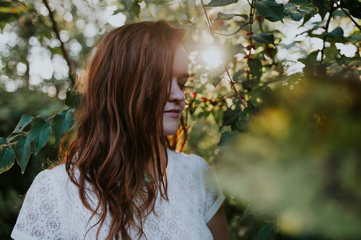 woman depth of field photography of woman wearing white lace top female