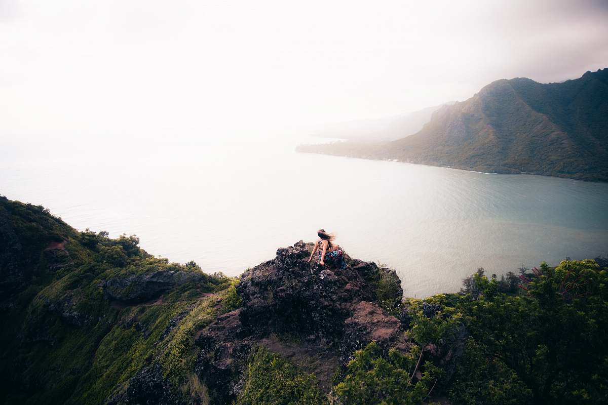 nature woman sitting on cliff outdoors