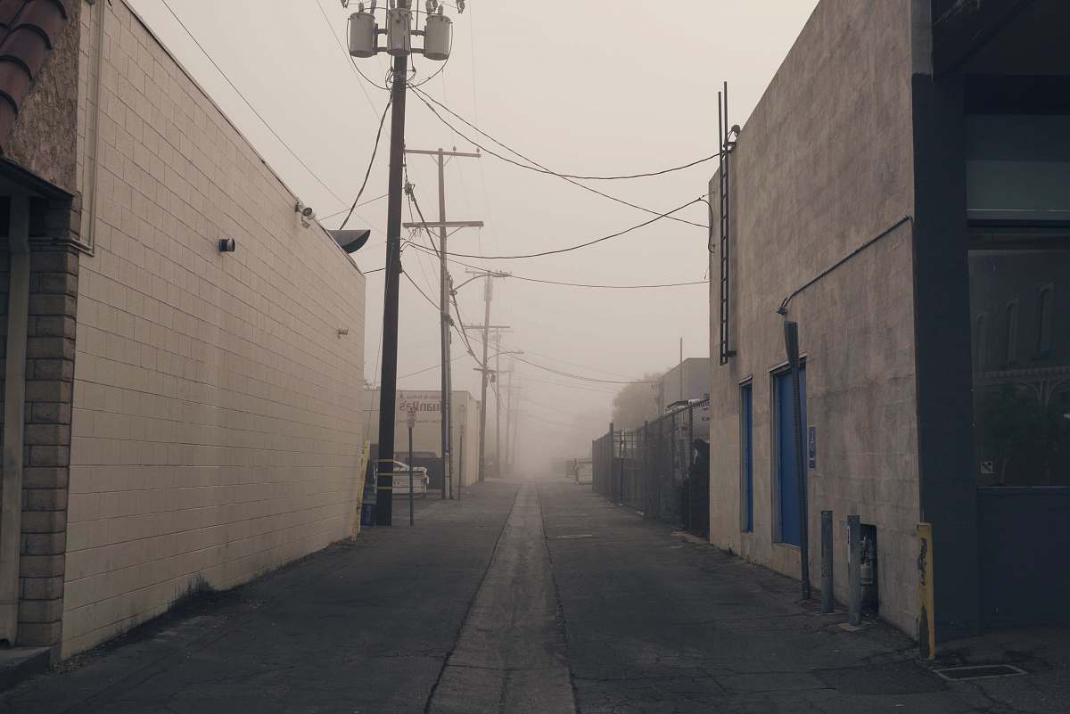 city gray concrete road under white sky at daytime alley