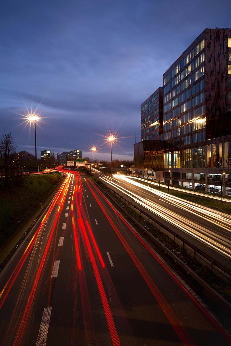 freeway time lapse photography of road beside high-rise building lille