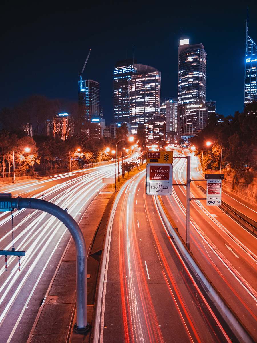 freeway timelapse photo of high-rise building highway