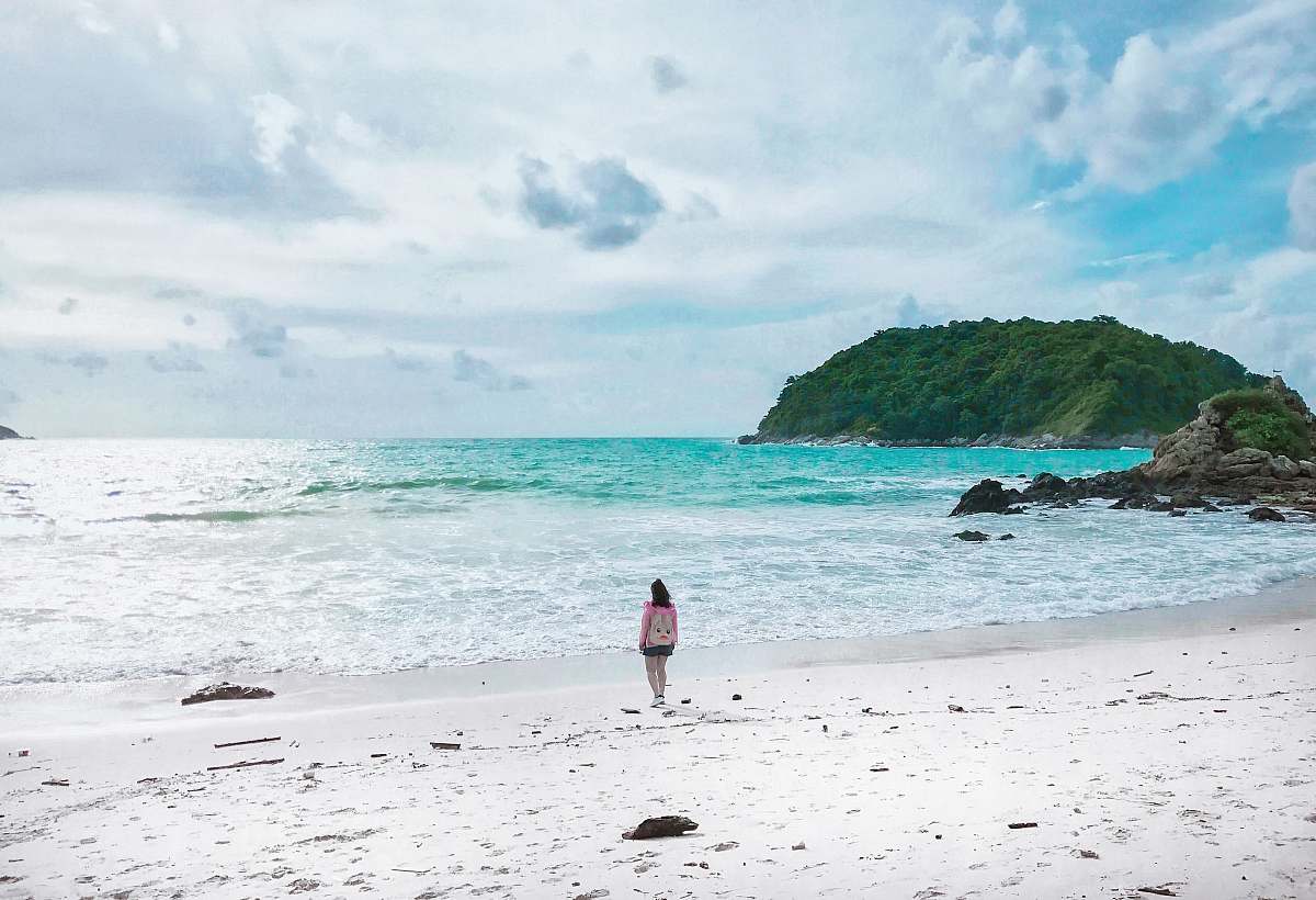 water women on shore during daytime promontory