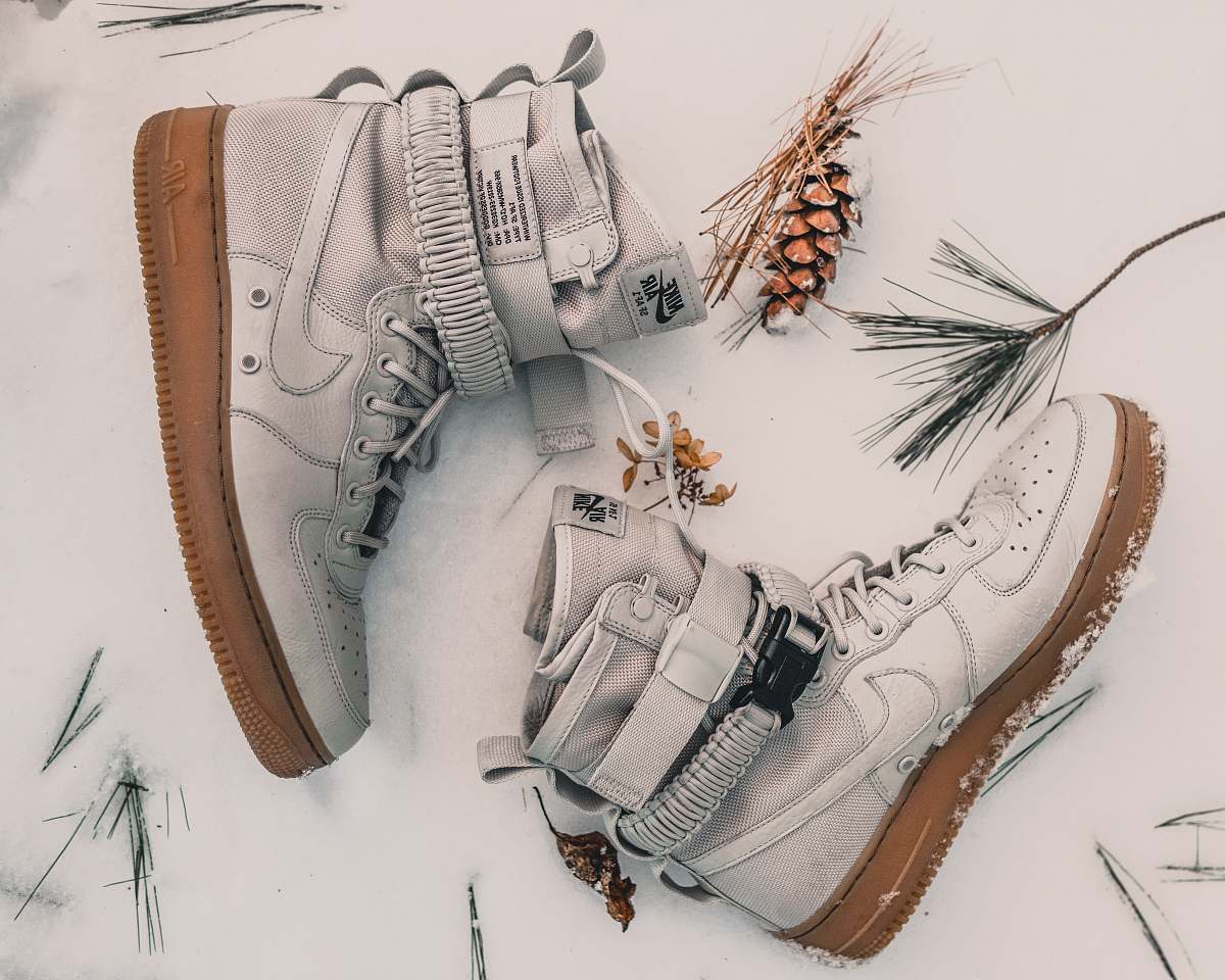 sneaker pair of gray Nike high-top sneakers on snow footwear