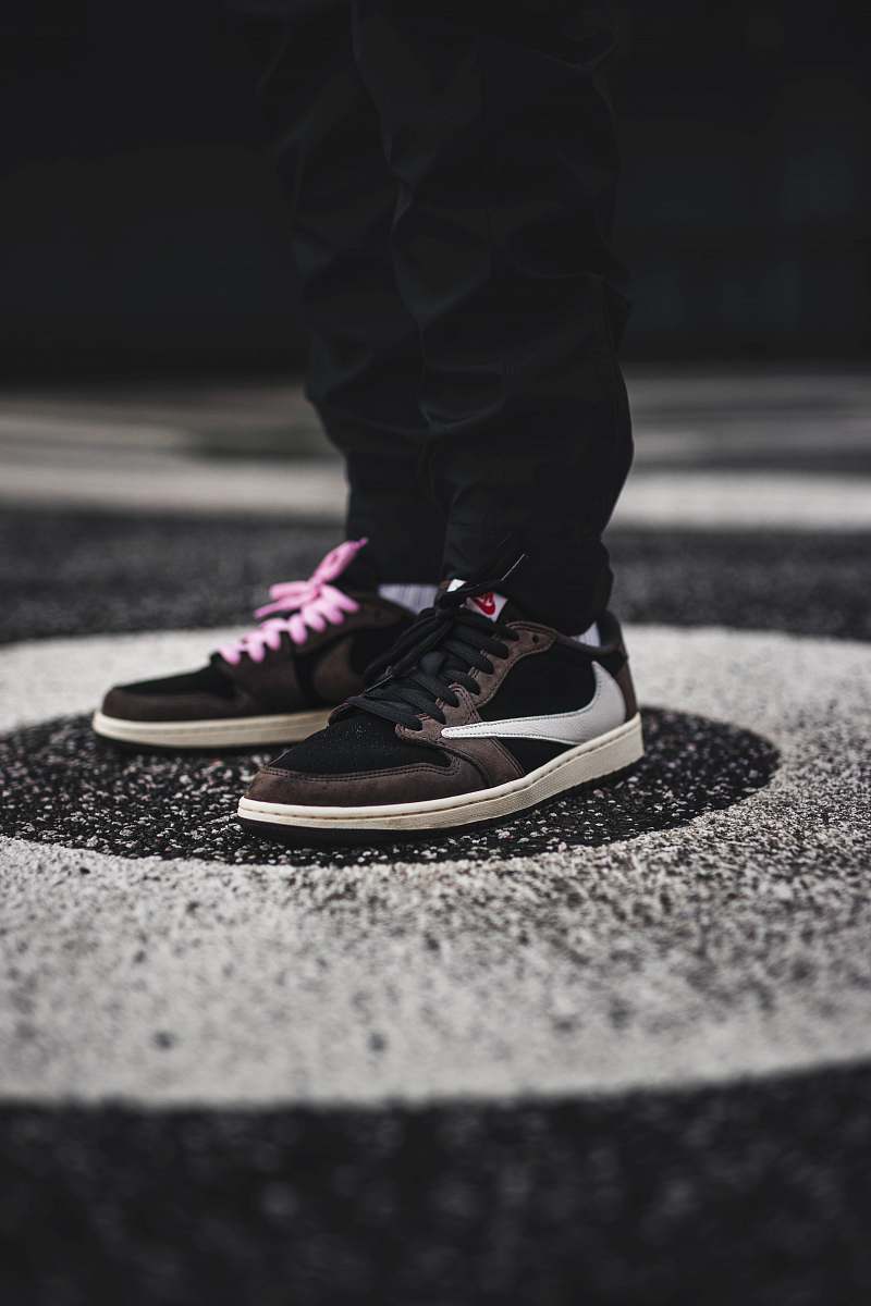 apparel person wearing brown and white Nike sneakers clothing