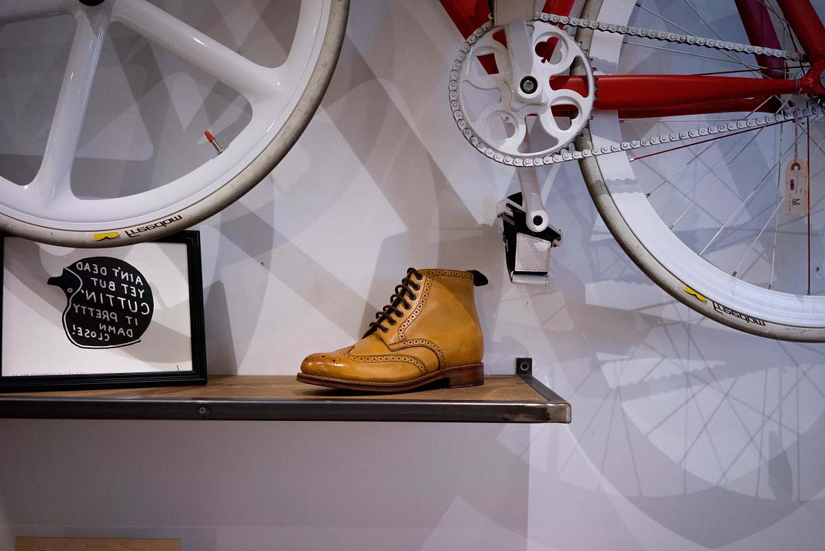 footwear unpaired brown leather wingtip shoe on floating shelf clothing