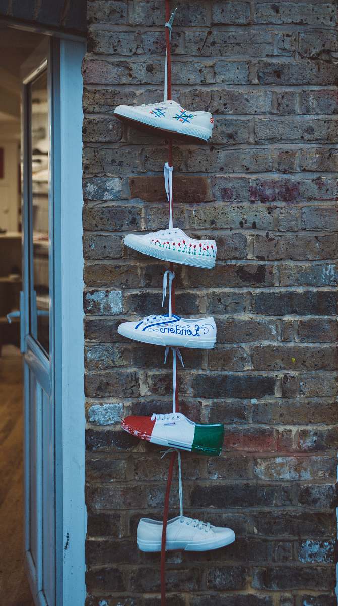 sneakers five white sneakers hanged near white door hanging