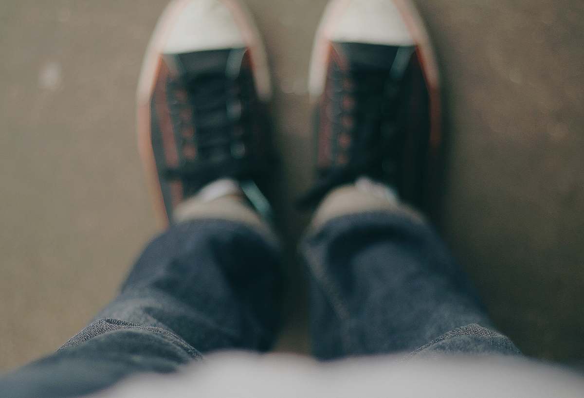 sneakers person wearing white-and-black low-top sneakers jeans