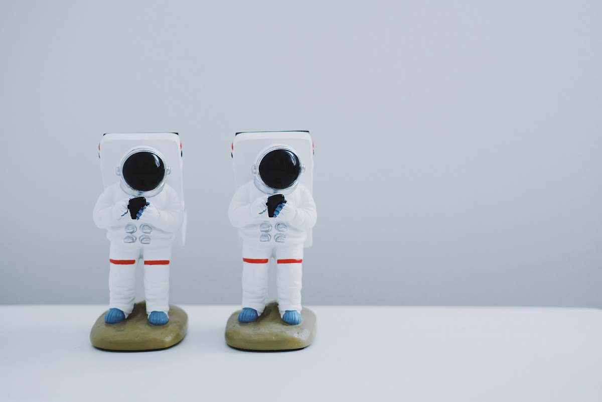 statue two spacesuit figurines on white surface toy