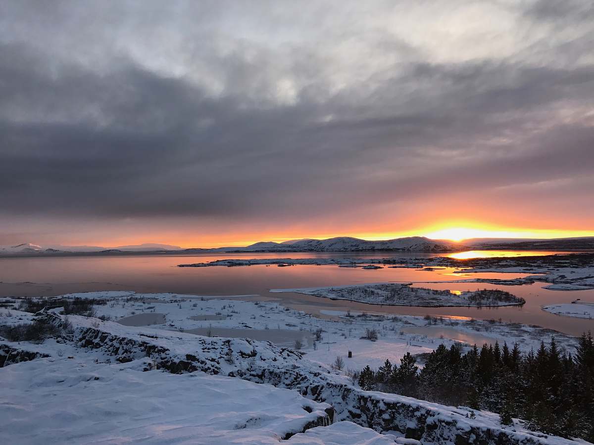 sunset aerial photo of snowed island sunrise