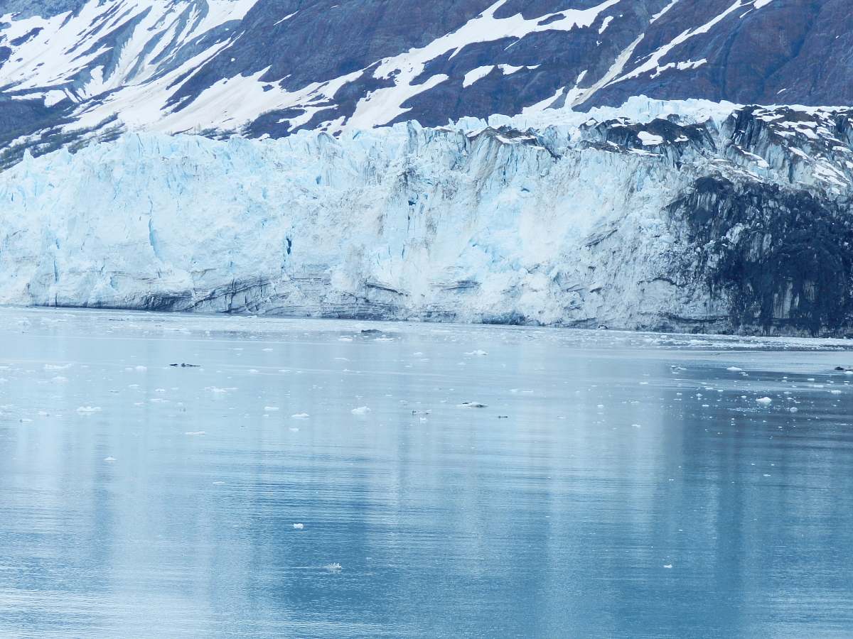 mountain mountain reflecting on body of water glacier