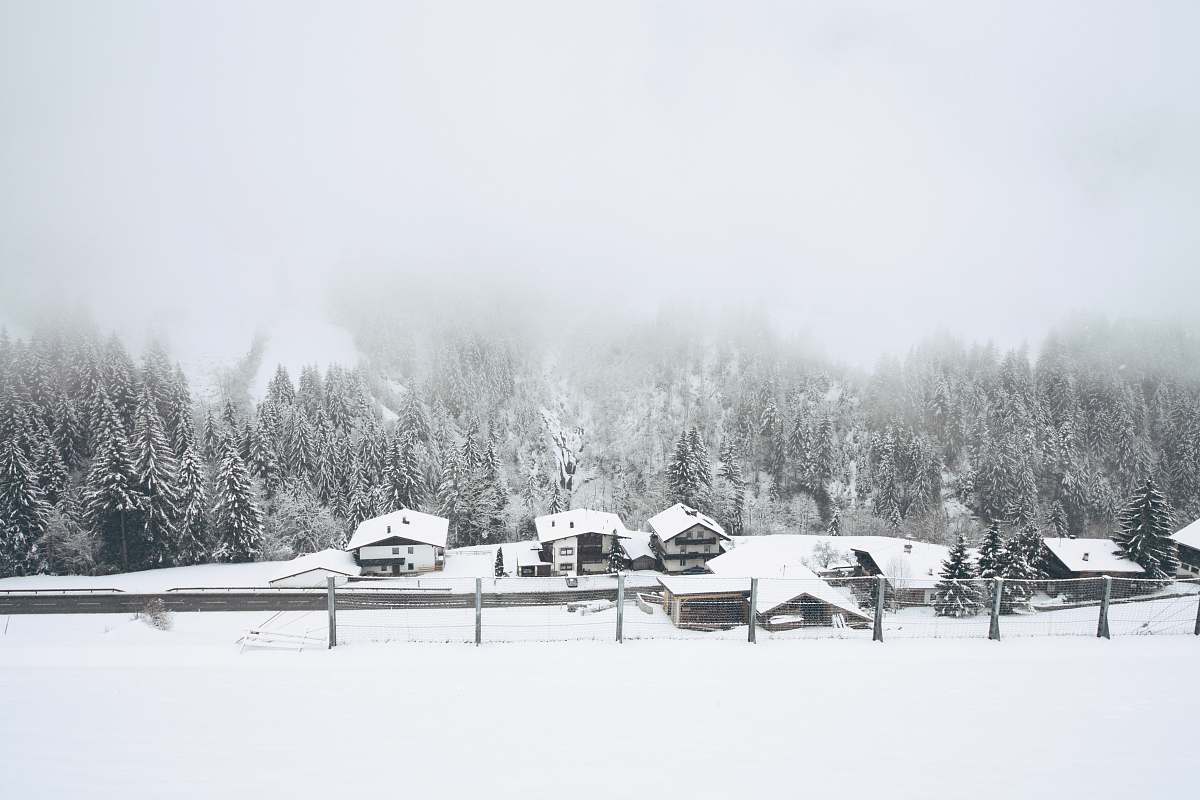 austria snow covered houses near trees winter