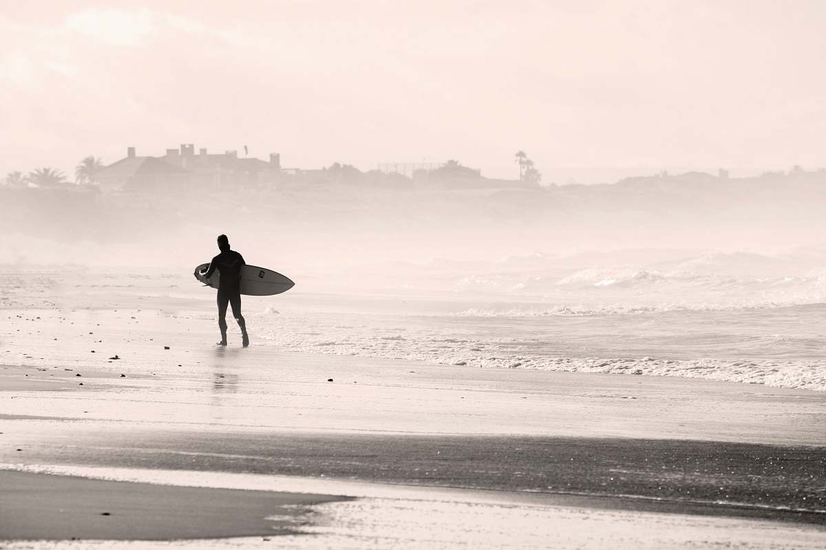 beach silhouette person walking on sandbank while holding surfboard sports