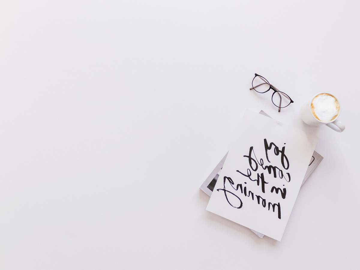 reading joy comes in the morning card beside coffee and eyeglasses white