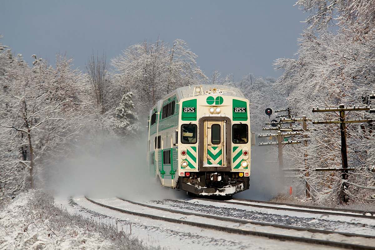 transportation white and green train on railway during daytime vehicle