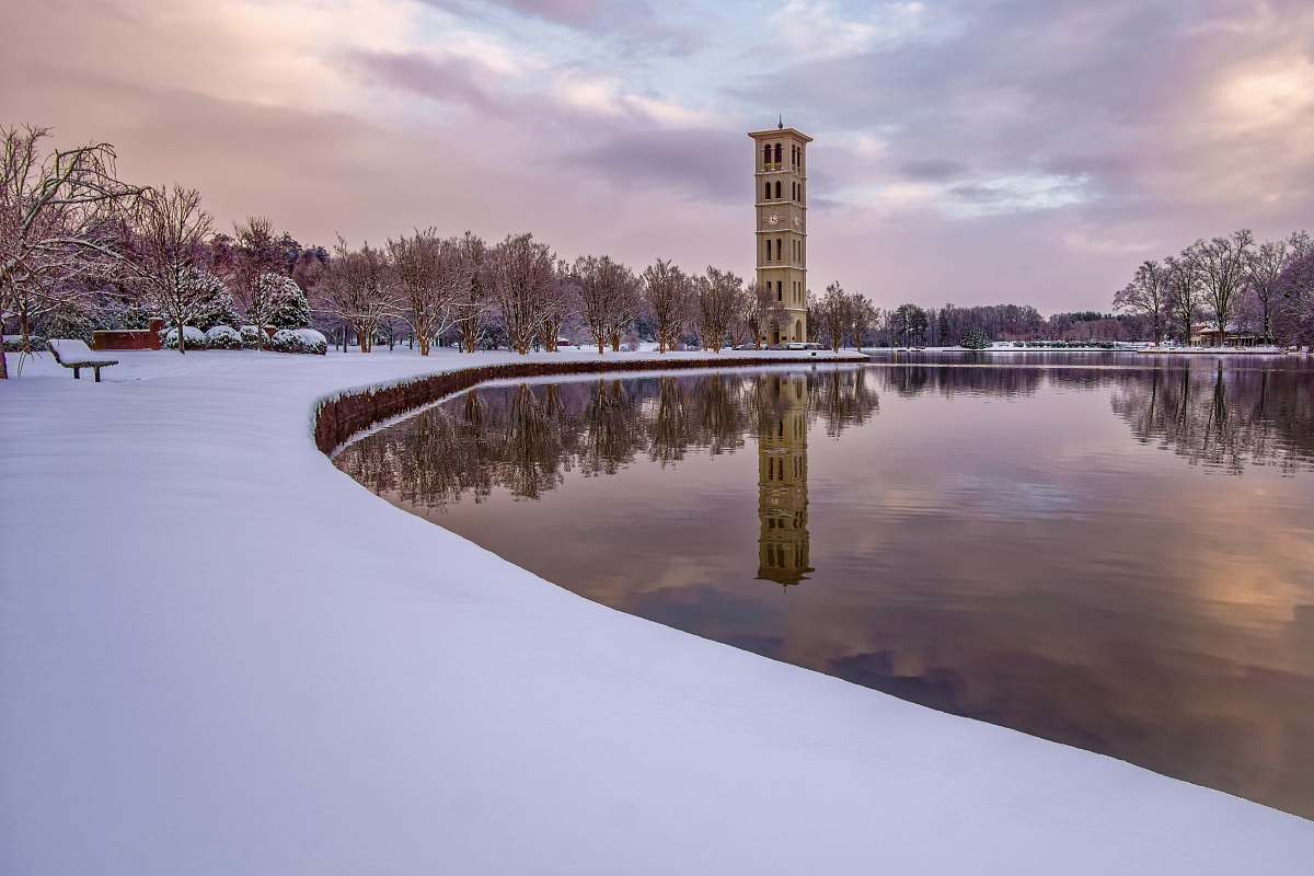 landscape tower near lake during daytime bell tower