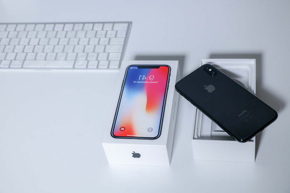 tunisia space gray iPhone X on table beside keyboard computer