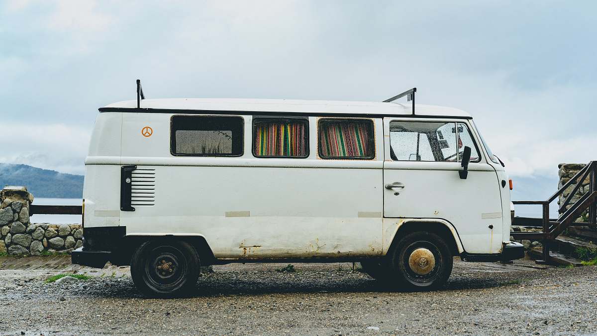 old parked empty white van under cloudy sky vehicle