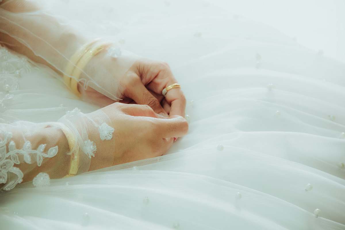 beautiful woman in white floral gown hands