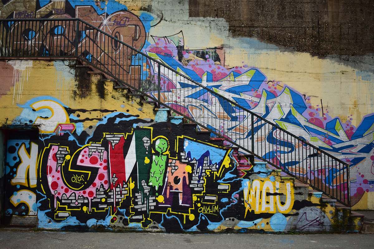 graffiti photo of white, pink, and blue graffiti railing
