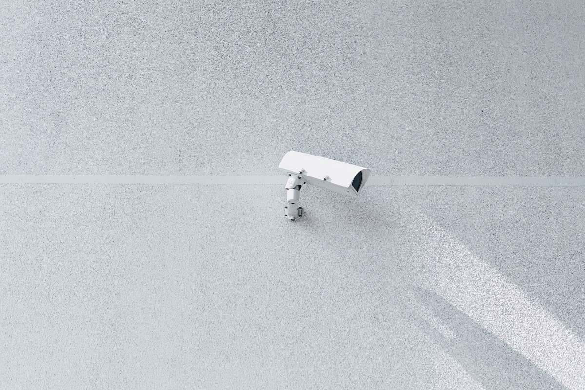 grey white box security camera on wall surveillance