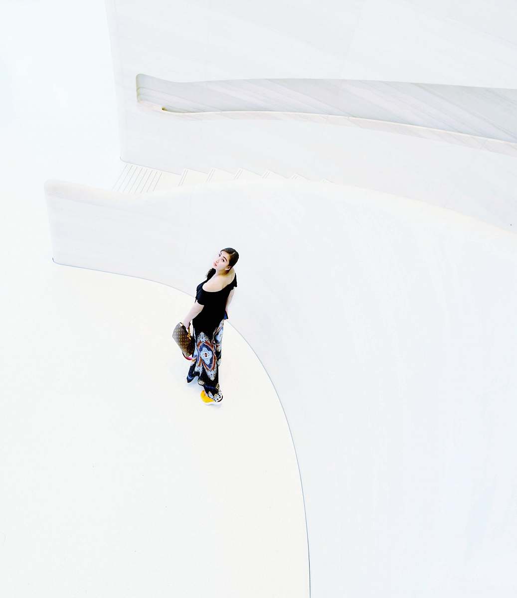 female woman standing beside stairs rail woman