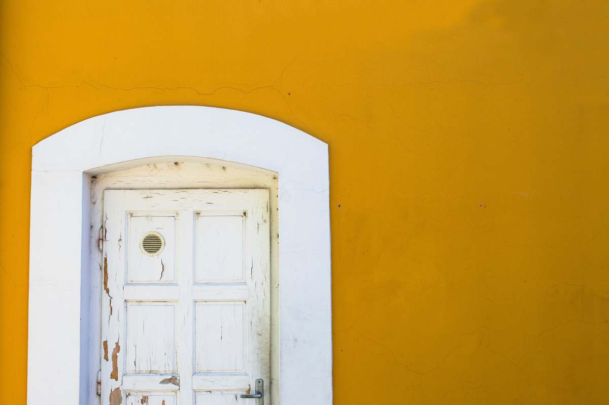 door yellow wall with white wooden door yellow