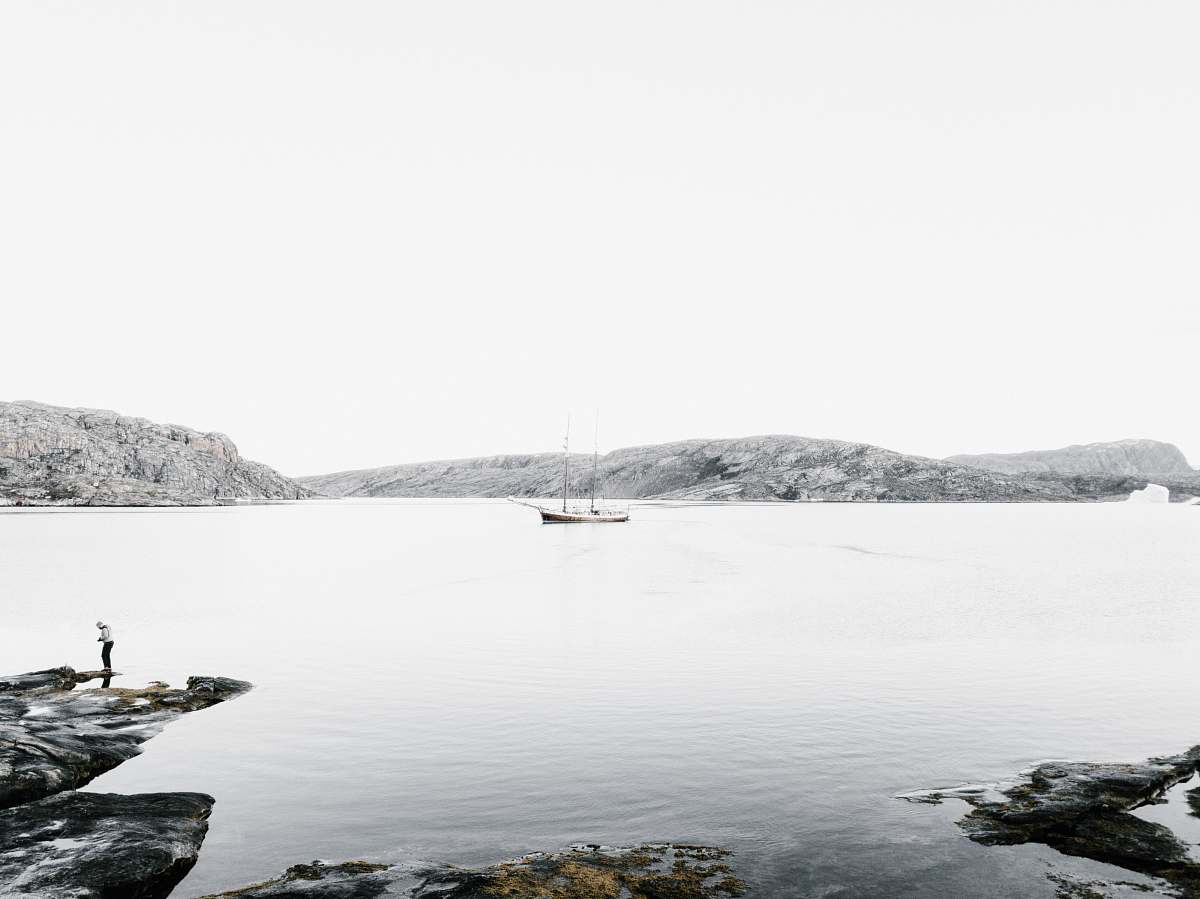 shoreline boat on body of water near island sea