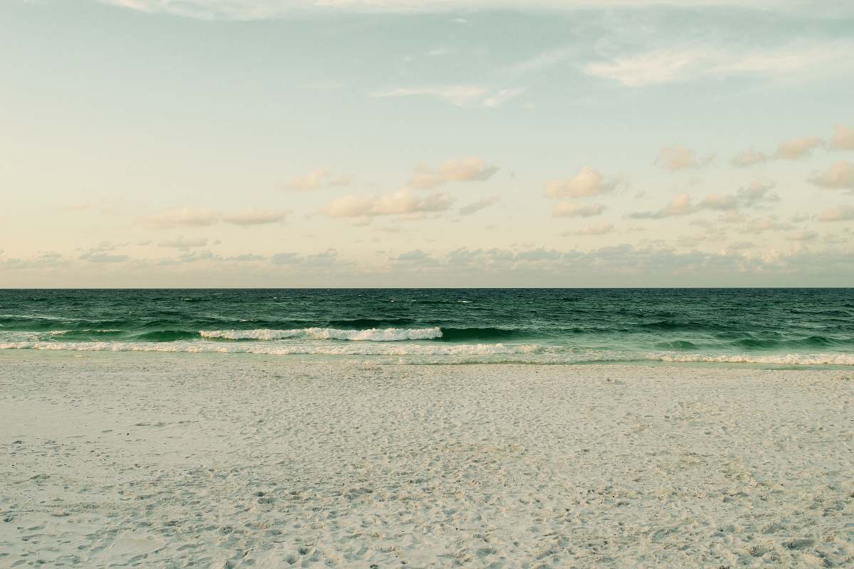 Immerse yourself in the breathtaking beauty of this serene beachside scene, where gentle waves caress a pristine sandy shore. This captivating beach photography captures the essence of relaxation, making it perfect for travel blogs, coastal lifestyle projects, and serene wallpaper designs. Whether you're looking to evoke feelings of calm or need imagery for beach-themed promotions, this image beautifully encapsulates the tranquility of coastal life.