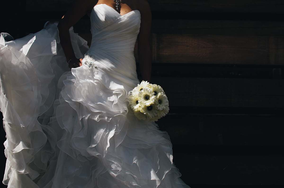 flower bride holding bouquet of flowers gown