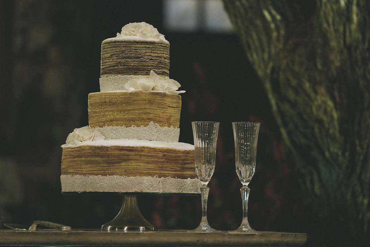 glass two clear wine glasses beside 3-layer towel cake cake