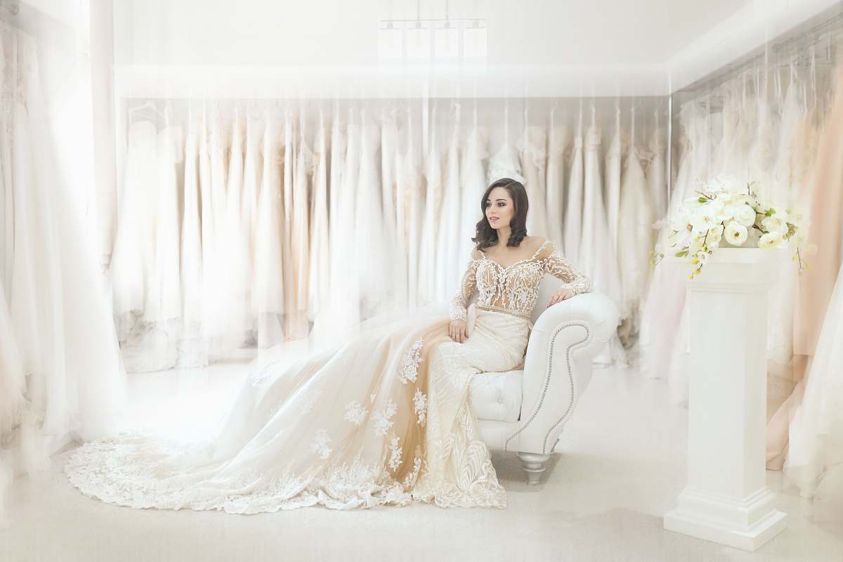 lace woman sitting on white leather armchair inside house dress