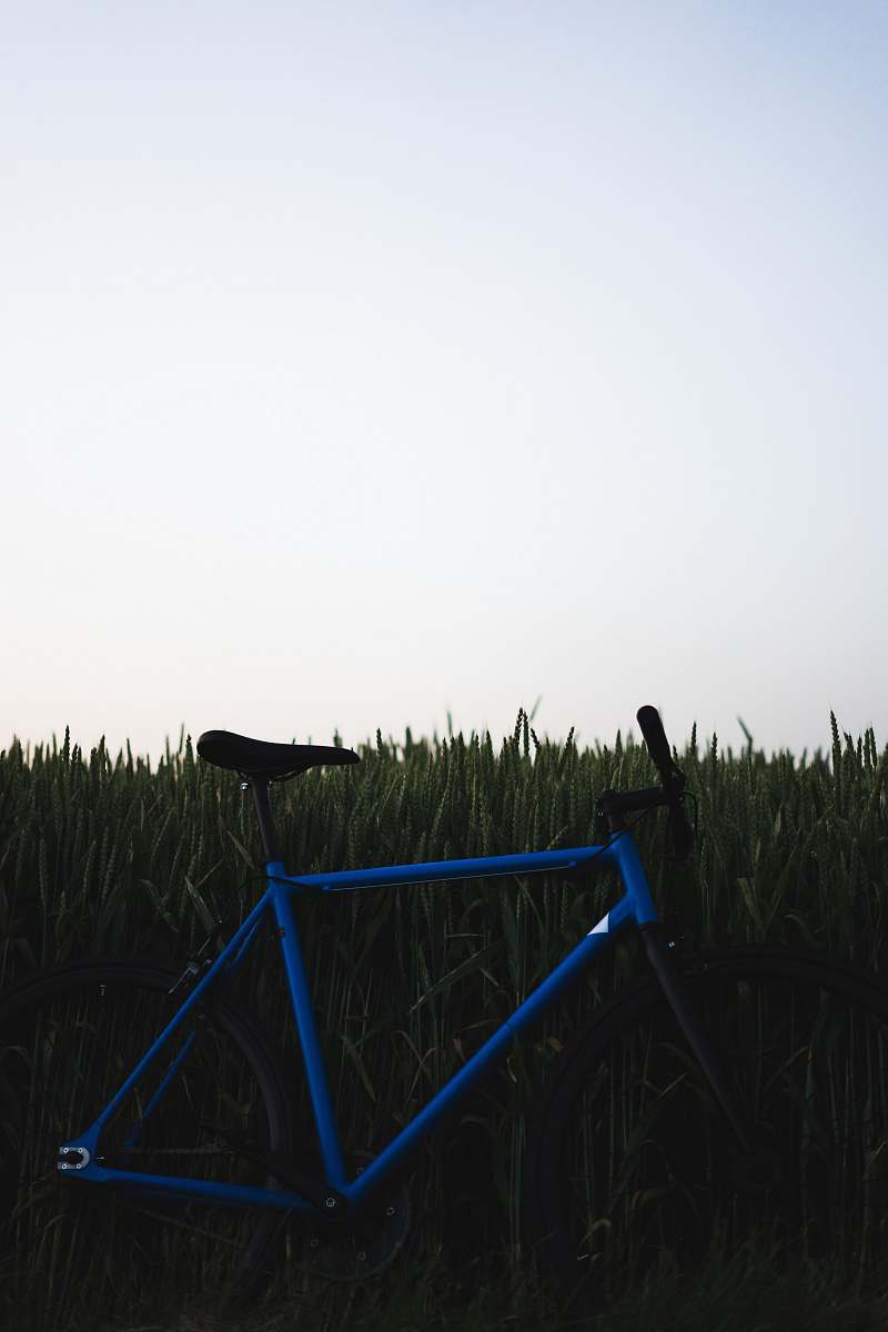 machine blue bicycle on grass field bike