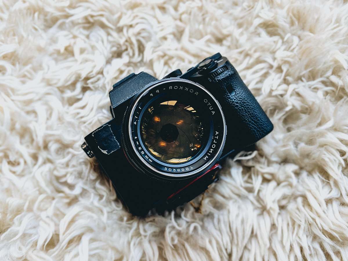 goggles black milc camera on white fur cloth minolta