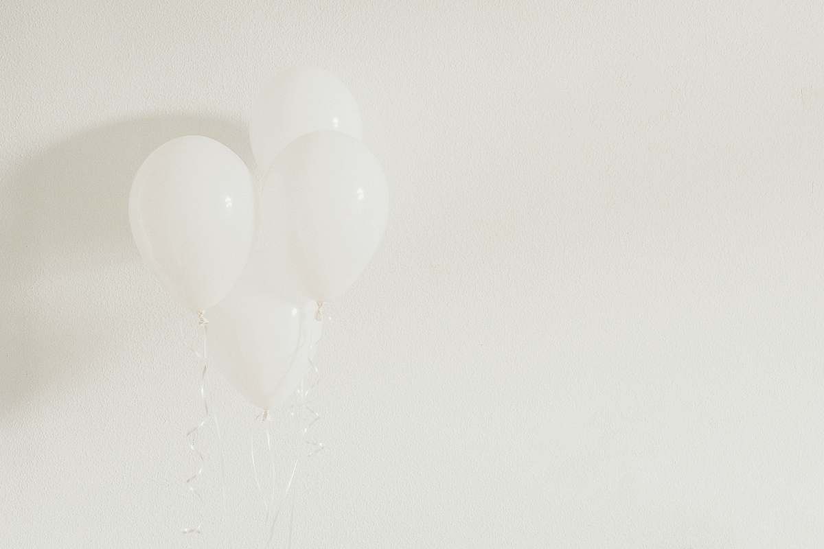 grey four white balloons on white wall white balloon