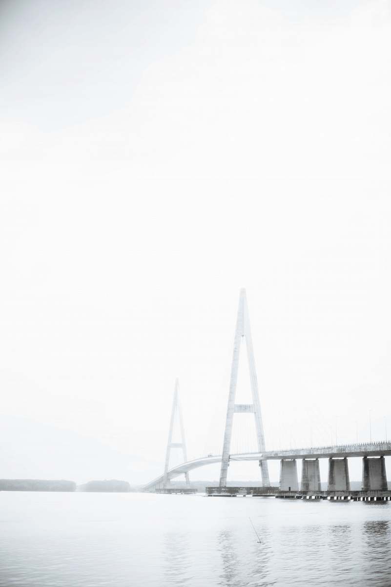 bridge gray bridge with clouds ocean