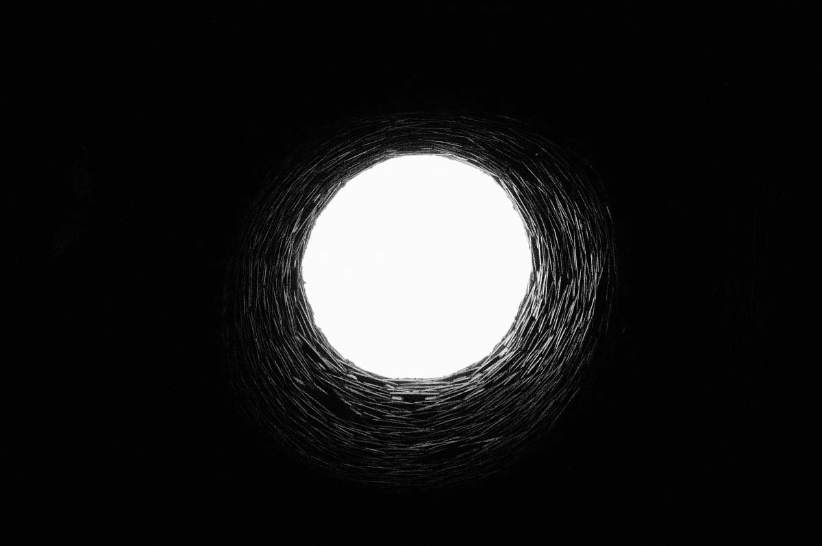 black-and-white long-angle photography of tunnel hole