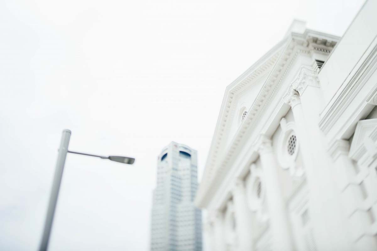 city low angle of white post light in front of white concrete building architecture