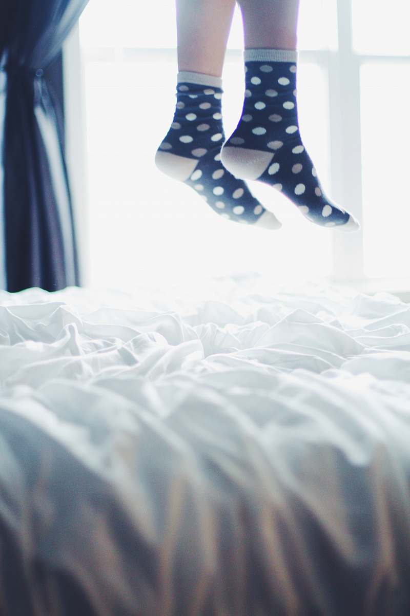feet pair of white-and-black polka-dot socks legs