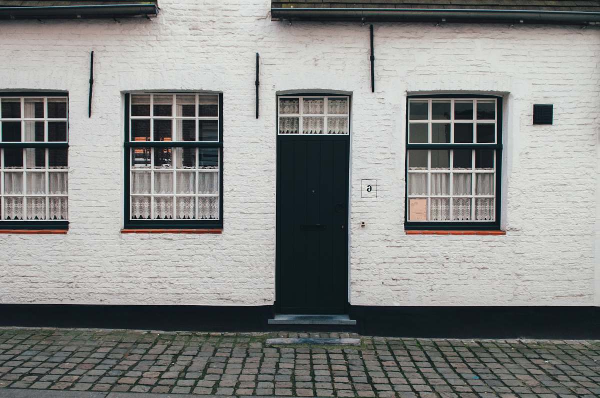 window photo of white concrete house city
